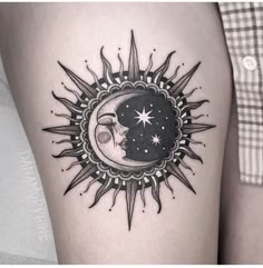 a woman's thigh with a sun and moon tattoo on it