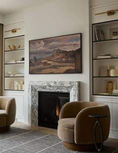 a living room filled with furniture and a fire place in front of a painting on the wall