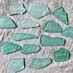 some green glass pieces with names on them