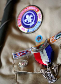 badges and pins on the back of a jacket