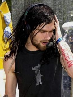 a man with long hair wearing headphones