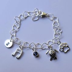 Personalized charm bracelet + Sterling silver heart (5.3 mm) bracelet with lobster clasp (can be adjusted upto 7 inch) + Sterling silver disk (9mm) + Sterling silver music note (10mm) + Sterling silver birthstone (5mm) + Sterling silver turtle charm (10mm) + Sterling silver paw print (8mm) * Every item comes in a pretty gift box * I can also make it with other charms in my shop, please contact me if you would like different designs Adjustable Charm Bracelet With Lobster Clasp For Birthday, Music-themed Silver Bracelet As A Gift, Personalized Adjustable Dangle Charm Bracelet, Silver Music-themed Bracelets For Gifts, Silver Music-themed Bracelet As Gift, Silver Music-themed Bracelet For Gift, Adjustable Nickel-free Charm Bracelet For Birthday Gift, Adjustable Nickel-free Charm Bracelet For Birthday, Adjustable Sterling Silver Charm Bracelet For Birthday