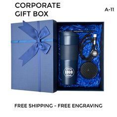 a blue gift box with a coffee cup and headphones in it next to a free shipping package