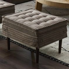 two upholstered footstools sit in front of a coffee table