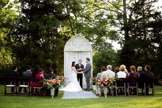 a bride and groom are standing at the alter