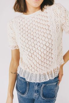 This vintage ivory top is a must-have with its crochet design, ruffle hem, and elegant mesh netting adorned with a delicate floral pattern and eyelets. Perfect for a stylish look that will turn heads. Lace Crochet Top With Lace Trim For Layering, Lace Tops With Crochet Trim For Layering, Spring Lace Mesh Top For Layering, Chic Lace Crochet Top With Pointelle Knit, Fitted Pointelle Knit Lace Top For Spring, Spring Lace Crochet Top For Layering, Crochet Lace Top For Layering, Spring Lace Crochet Layered Top, Fitted Chic Pointelle Knit Lace Top