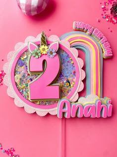 a pink birthday cake with the number two on it