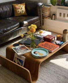 a coffee table with flowers and books on it