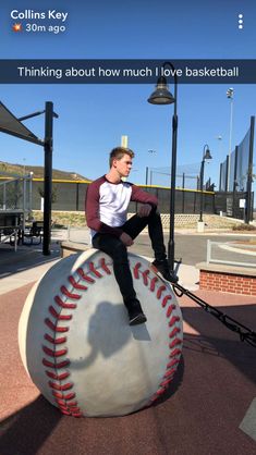 a man sitting on top of a baseball ball