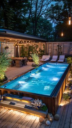 an above ground swimming pool surrounded by decking and lights in the middle of a backyard