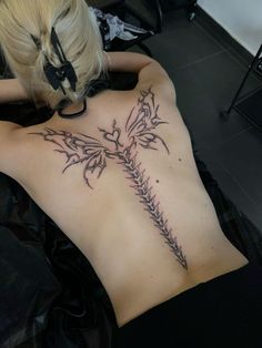 a woman with a tattoo on her back