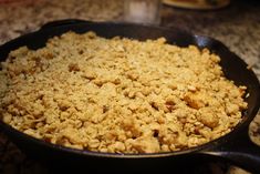 a skillet filled with food sitting on top of a counter