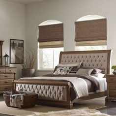 a bedroom with a bed, dresser and mirror