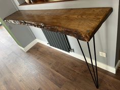 a wooden table with hair pins on it in front of a mirror and wood flooring