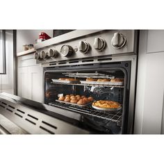 an oven with several trays of food cooking in it's door and shelves