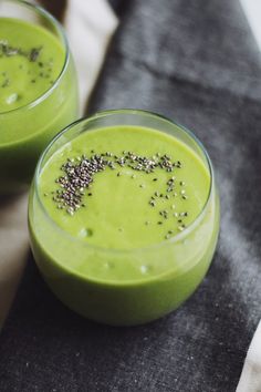 two glasses filled with green smoothie and sprinkles