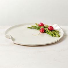 asparagus and radishes on a white plate