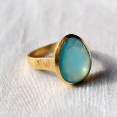 D E T A I L S - Material: Sterling silver 925 Stone: Aqua Chalcedony The fit: True to US ring size Finish: Smooth and Gold Plated to a high shine S H I P P I N G & P R O D U C T I O N - My current production time is 2-6 business days, which means after those days are up, your order ships! I make everything custom to order, by hand, but I promise you it's worth the wait! R U S H - M Y - O R D E R - If you're in a rush to get your pretty new pieces, please send me a message and I'll let you kn Yellow Gold Chalcedony Ring Gift, Chalcedony Rings Fine Jewelry For Gift, Handmade Gold Chalcedony Rings, Fine Jewelry Chalcedony Gemstone Rings, Handmade Yellow Gold Teardrop Ring, Handmade Moonstone Ring For Anniversary, Elegant Chalcedony Rings For Gift, Anniversary Chalcedony Ring With Polished Finish, Oval Chalcedony Rings Fine Jewelry