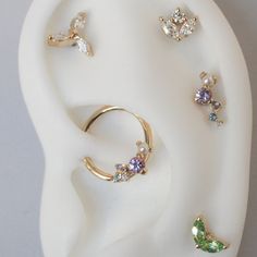 an ear with five different colored stones on it