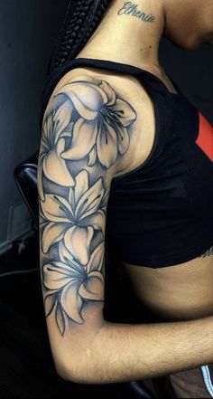 a woman with a flower tattoo on her arm