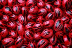 a pile of red and black balls sitting on top of each other