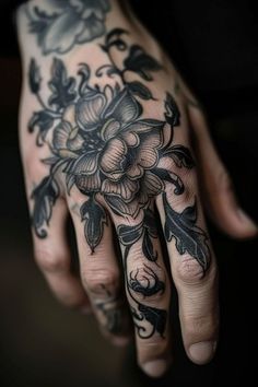 a tattooed hand with flowers on it