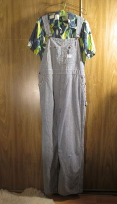 These 60s vintage overalls are gently distressed blue and white stripe cotton denim, Penneys Big Mac Square Bak overalls. Union Made and Sanforized. The denim in this pair of overalls is gently worn with fade marks and small rips, and still quite sturdy.  Made in the USA. Lots of overalls details and pockets with lots of white and red accent stitching. They have  wear at the edges and the back hems. They have adjustable straps and a big pocket on the front and long straps. These have overall hoo Striped Cotton Overalls, Striped Cotton Overalls For Spring, Spring Striped Cotton Overalls, Retro Cotton Overalls With Relaxed Fit, Vintage Cotton Relaxed Fit Overalls, Vintage Relaxed Fit Overalls, Costumes With Overalls, Vintage Overalls, Big Pocket