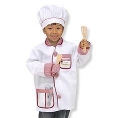 a young boy dressed as a chef holding a spatula