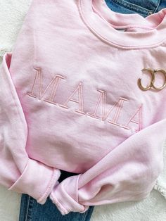 "To the Mamas out there, you are the real MVPs. We all know one or we are one, so show that mama a little love with our cozy and cute Mama sweatshirt! - Unisex sizing. - 50% cotton / 50% Polyester - Air jet yarn , softer feel and reduced pilling Model wearing size medium (normally a size 4, 5'6\" tall). Sample shown in light pink with baby pink thread. *NOT PROVIDING ALL OF THE REQUIRED INFORMATION FOR PERSONALIZATION WILL DELAY YOUR ORDER.** When checking out, put this information in the \"NOTE Casual Tops With Name Print For Loungewear, Long Sleeve Tops For Mother's Day Loungewear, Cute Cotton Sweatshirt For Everyday, Cute Everyday Cotton Sweatshirt, Customizable Trendy Pink Tops, Cute Cotton Everyday Sweatshirt, Customizable Cute Cotton Sweatshirt, Cute Customizable Crew Neck Sweatshirt, Family Matching Pink Tops For Fall