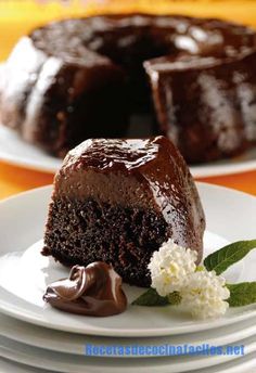 a chocolate cake on a plate with a piece cut out