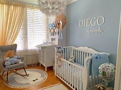 a baby's room decorated in blue and white