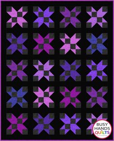 an image of a purple and black quilt with stars on the front, in different colors