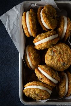 carrot cookies with white frosting in a tin