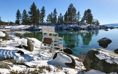 a white chair sitting on top of snow covered rocks