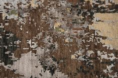 an area rug with many different colors and patterns on the carpet, including brown, beige, green, black, gray and white