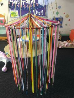 a room filled with lots of colorful streamers hanging from the ceiling