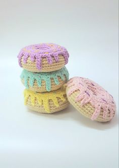 three crocheted donuts sitting next to each other on a white table top