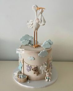 a baby shower cake with a stork on top