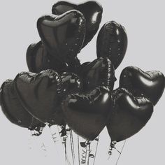 a bunch of black heart shaped balloons in the shape of hearts on a white background