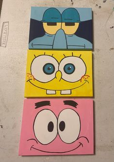 three cartoon characters painted on canvases sitting on top of each other in different colors