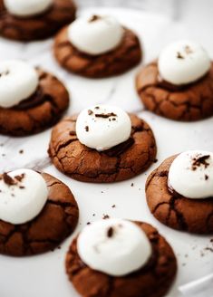 chocolate cookies with marshmallows and cream on top