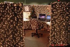 an office cubicle decorated with christmas lights