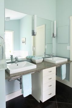 a bathroom with two sinks and mirrors in it