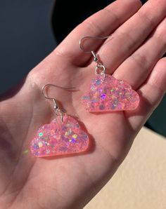 "Each pair of resin earrings are made to order, therefore no two pairs are identical! However, I try to get as close as possible :) Made with nickel free, hypoallergenic fish hooks.  Each cloud is approximately 1.25\" wide and has pink holographic chunky mix glitter ✨ Thanks for visiting my shop! ☁️" Handmade Clear Resin Earrings, Cute Resin Drop Earrings, Whimsical Nickel-free Resin Earrings, Whimsical Pink Resin Earrings, Unique Pink Resin Earrings, Cloud Earrings, Pink Holographic, Edc Outfits, Fish Hooks