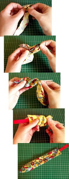 the hands are holding fabric together to make an origami flower bouquet with ribbon