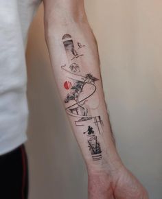 a person with a tattoo on their arm that has an image of a lighthouse and palm trees