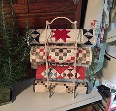 three quilted bags stacked on top of each other