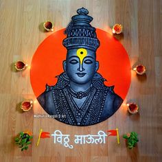 an image of buddha in the center of a circle with candles around it on a wooden floor