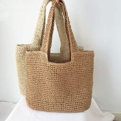 Chic Sand-colored Summer Shoulder Bag, Beachy Sand-colored Beach Bag With Braided Handles, Beach Season Shoulder Bag With Braided Handles, Shoulder Bag With Braided Handles For Beach Season, Chic Beach Bag Made Of Natural Fiber, Summer Woven Sand-colored Shoulder Bag, Beige Tote Shoulder Bag For Vacation, Trendy Shoulder Bag With Braided Handles For Beach Season, Summer Style Sand-colored Shoulder Bag