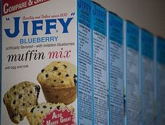 a box of blueberry muffins sitting on top of a shelf next to other boxes